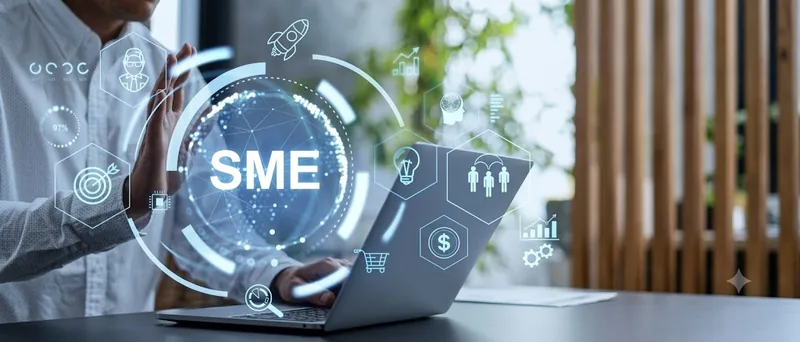 Person at a laptop with an SME hologram and business icons