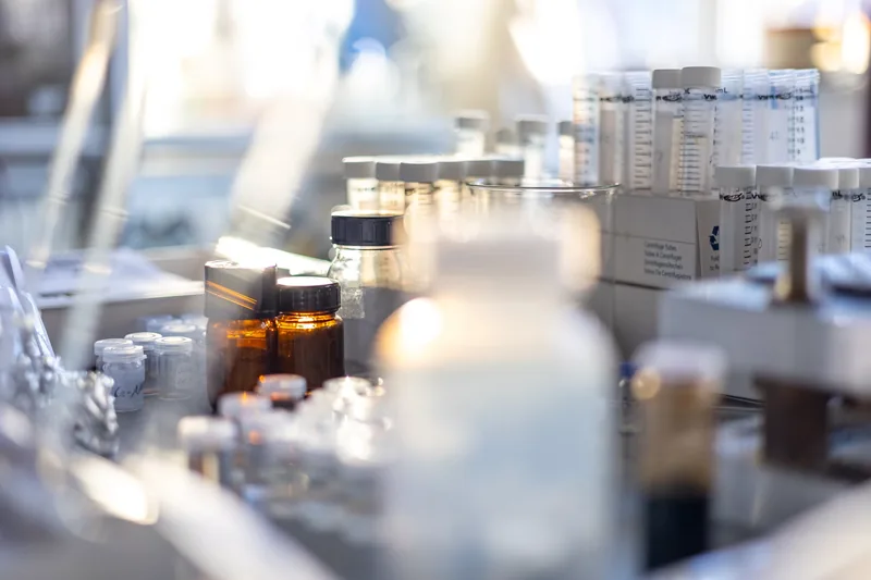 Bottles and glassware on a pharmacy laboratory bench