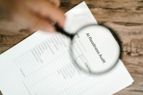 A magnifying glass over a printed AI readiness audit